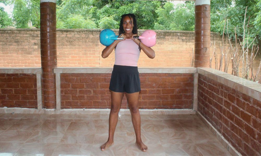 An image demonstration holding two kettlebells performing the move called a Double Racked Hold