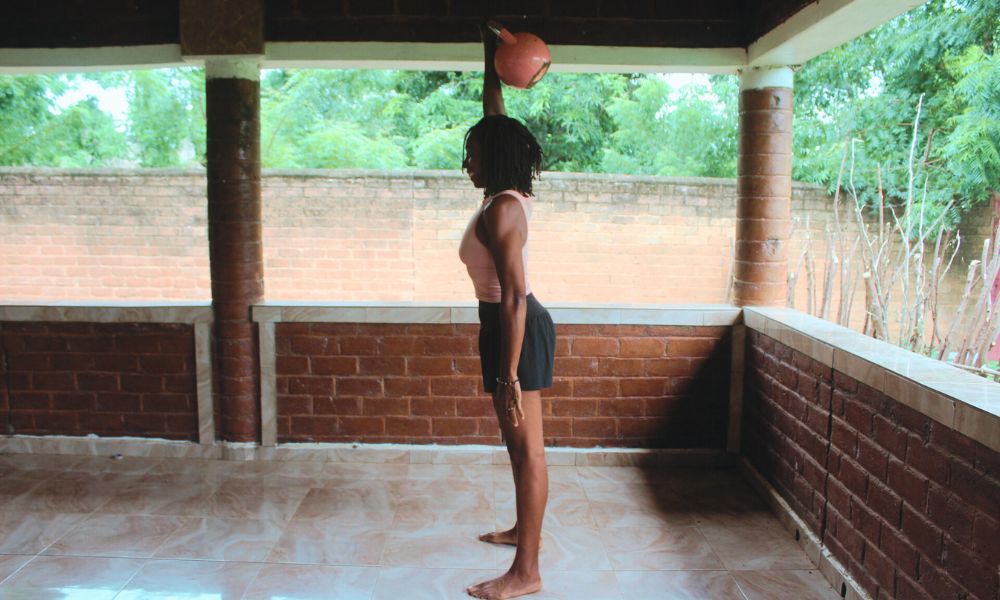 An image demonstrating a kettlebell move called the overhead hold