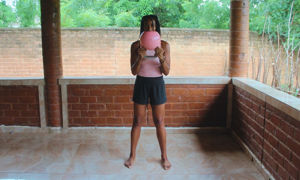 An image demonstration showing how to do a kettlebell move know as a Horn Hold